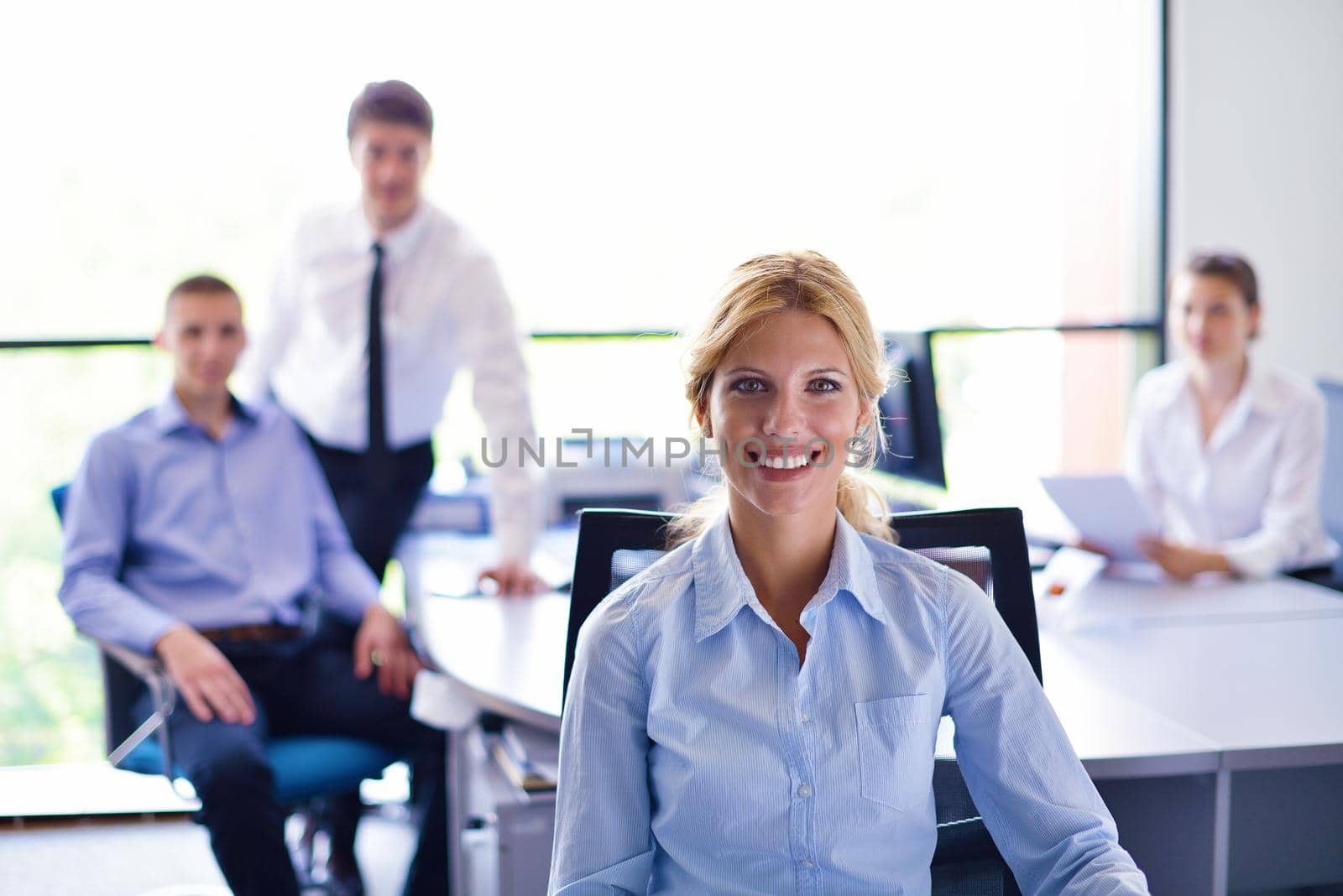 business woman  with her staff,  people group in background at modern bright office indoors