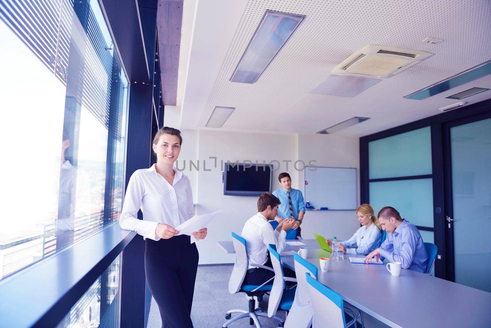 business woman  with her staff,  people group in background at modern bright office indoors