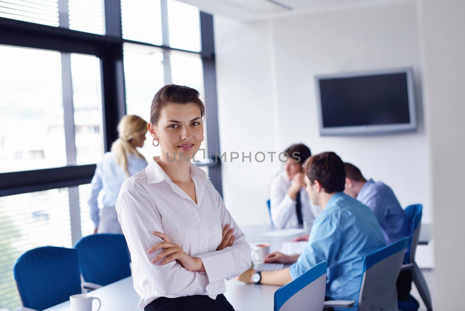 business woman  with her staff,  people group in background at modern bright office indoors