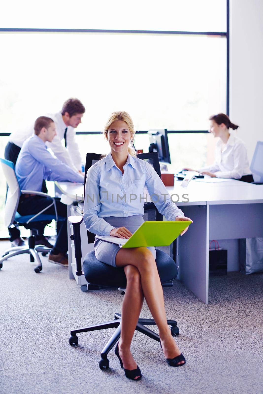 business woman  with her staff,  people group in background at modern bright office indoors