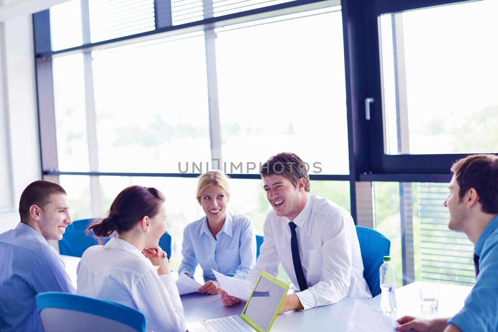 Group of happy young  business people in a meeting at office