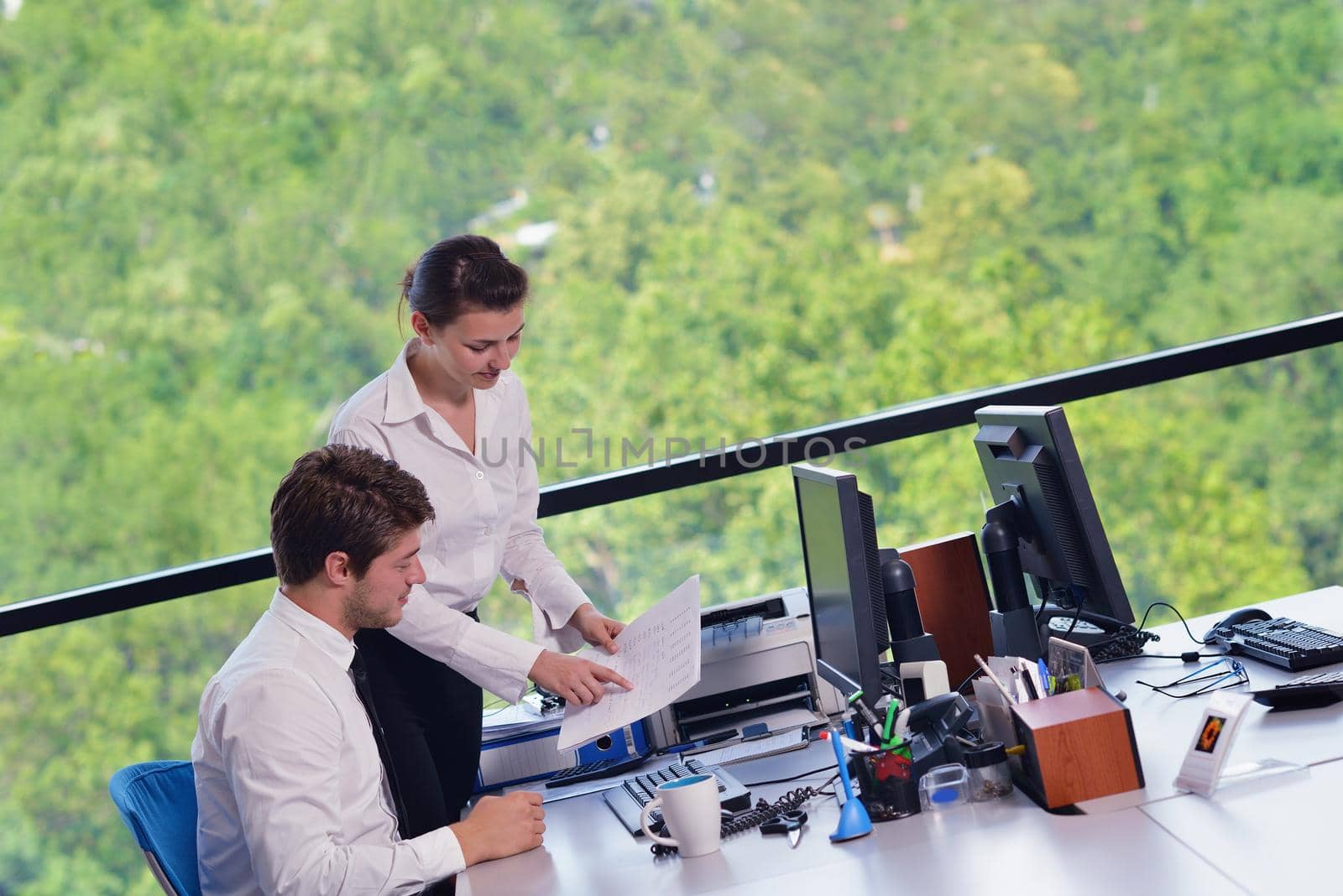 Group of happy young  business people in a meeting at office