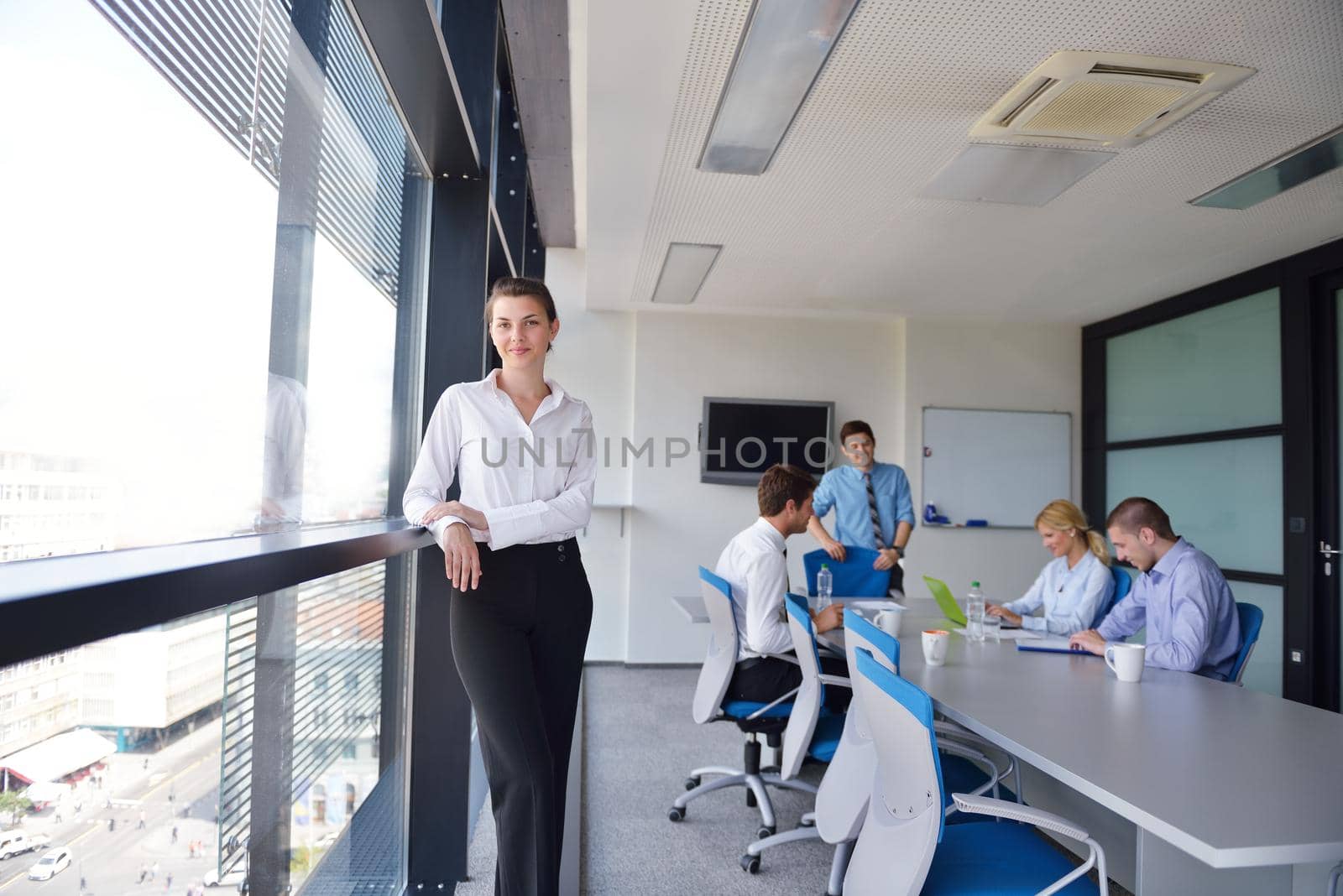 business woman  with her staff,  people group in background at modern bright office indoors