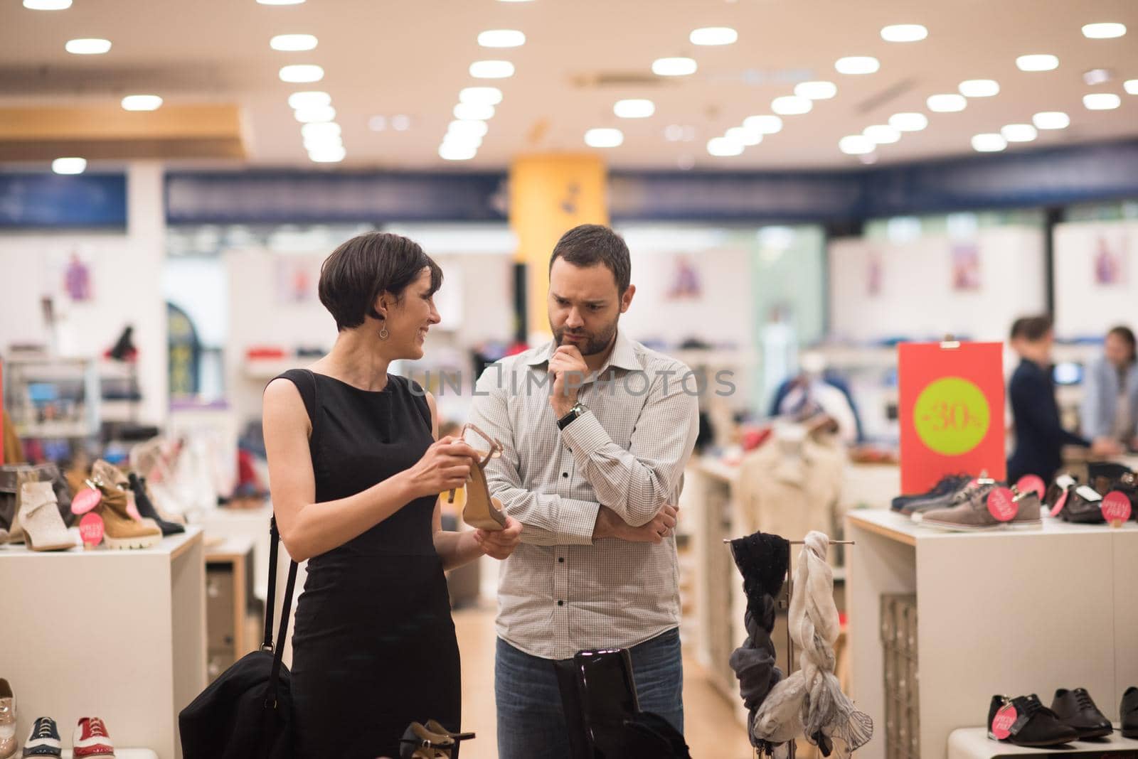 A young attractive couple changes the look with new shoes  At Shoe Store