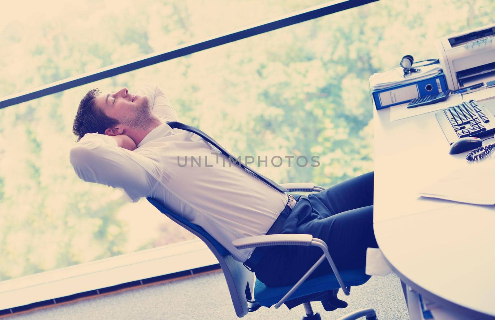 happy young business man at office by dotshock