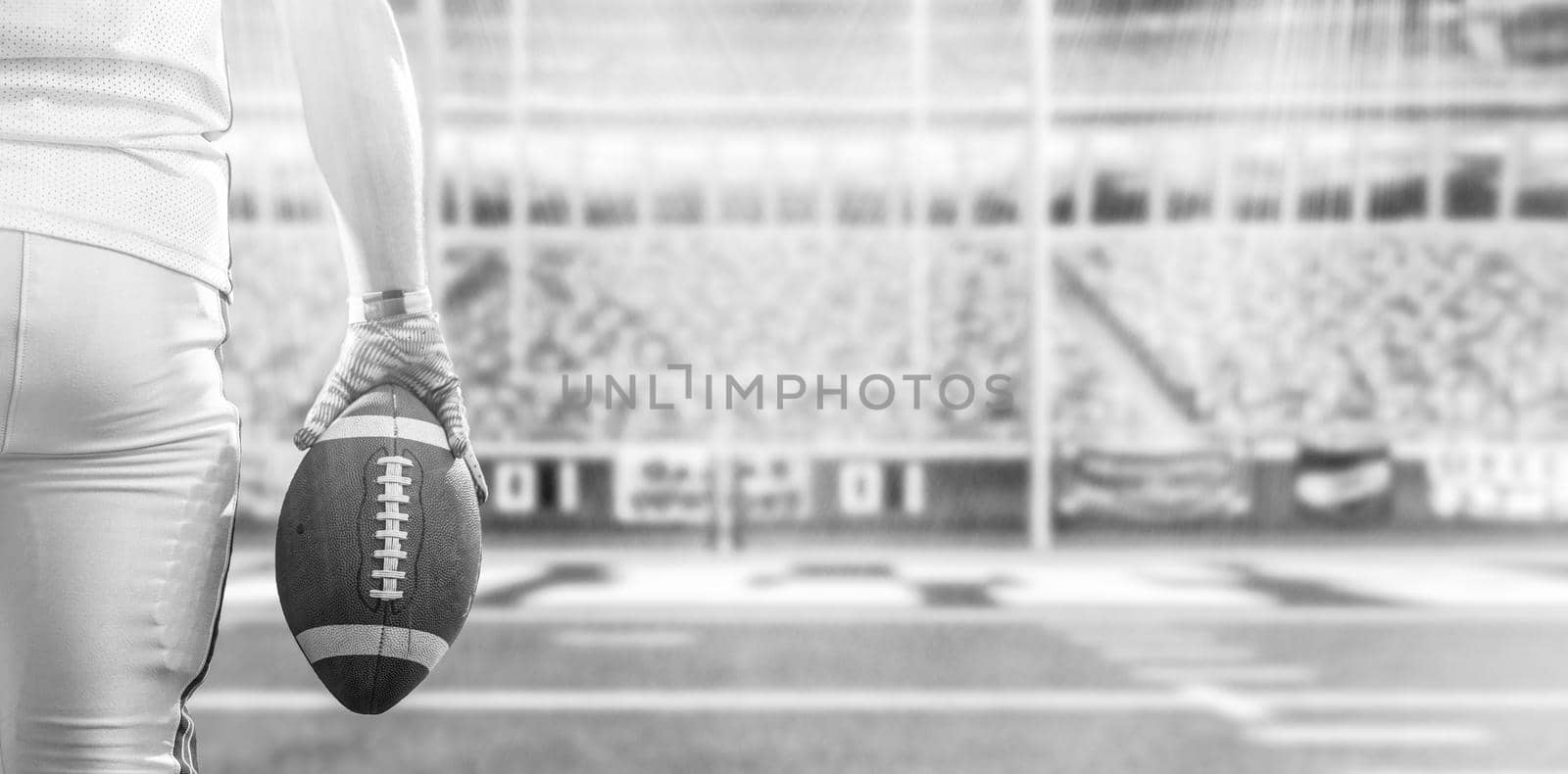 Closeup Portrait of a strong muscular American Football Player on big modern stadium field with lights and flares