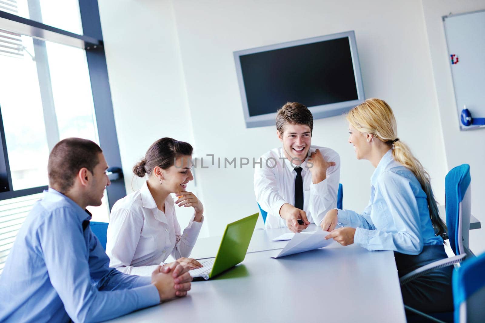 Group of happy young  business people in a meeting at office