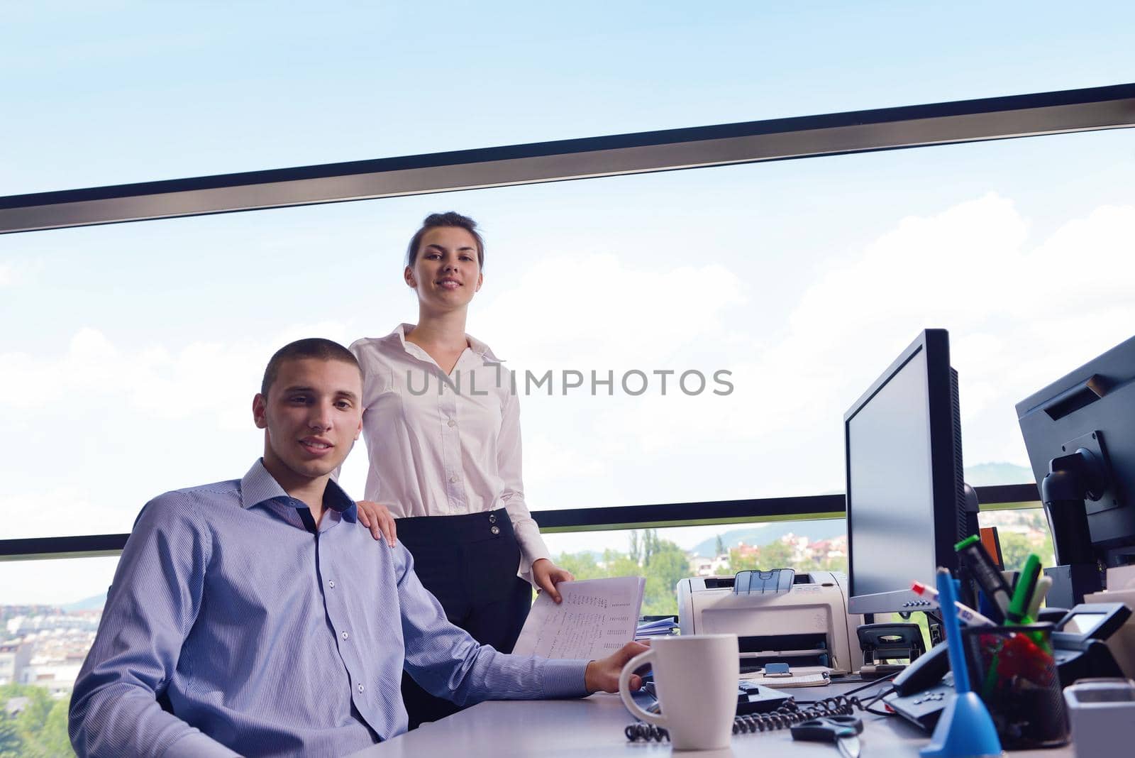 Group of happy young  business people in a meeting at office