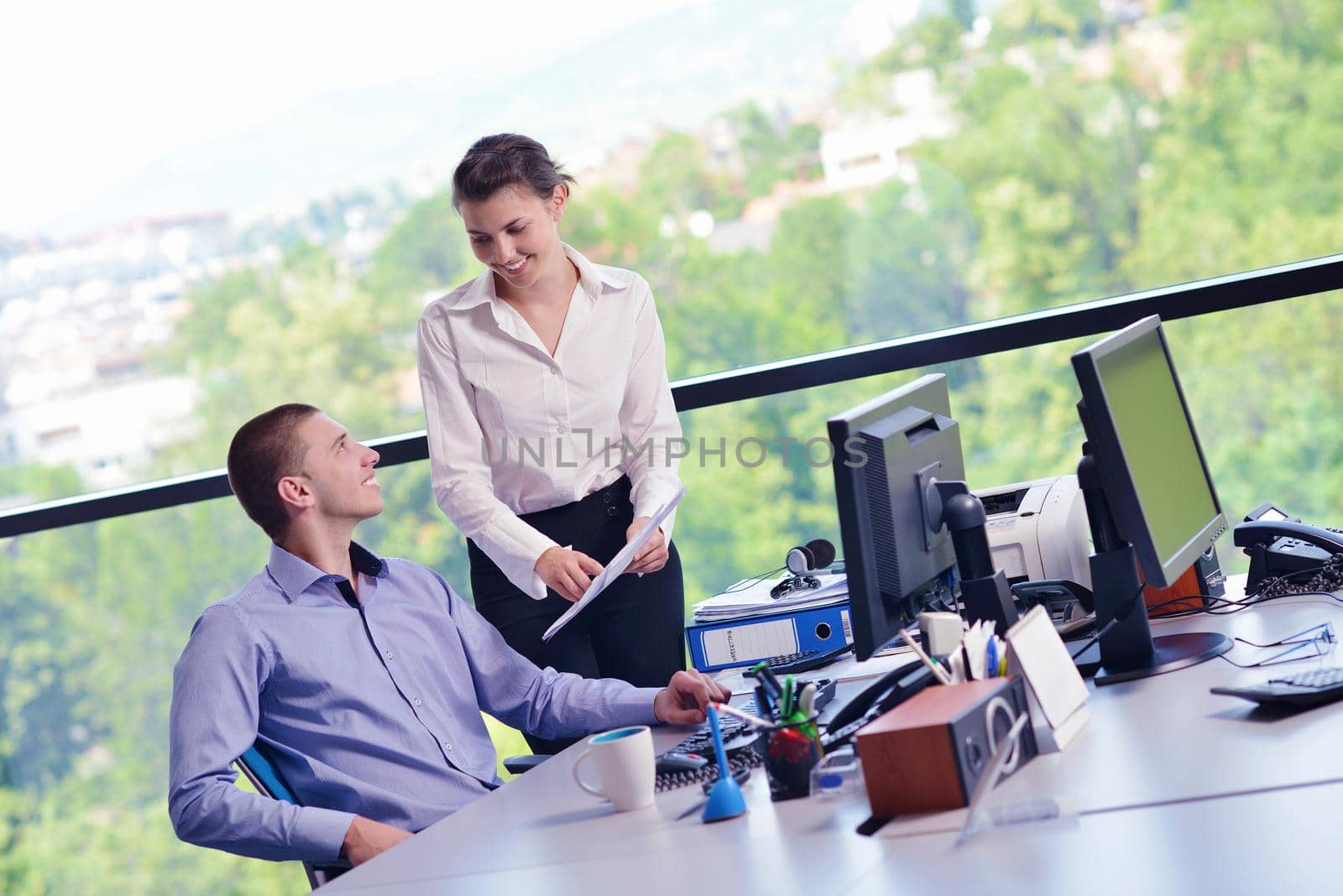 Group of happy young  business people in a meeting at office