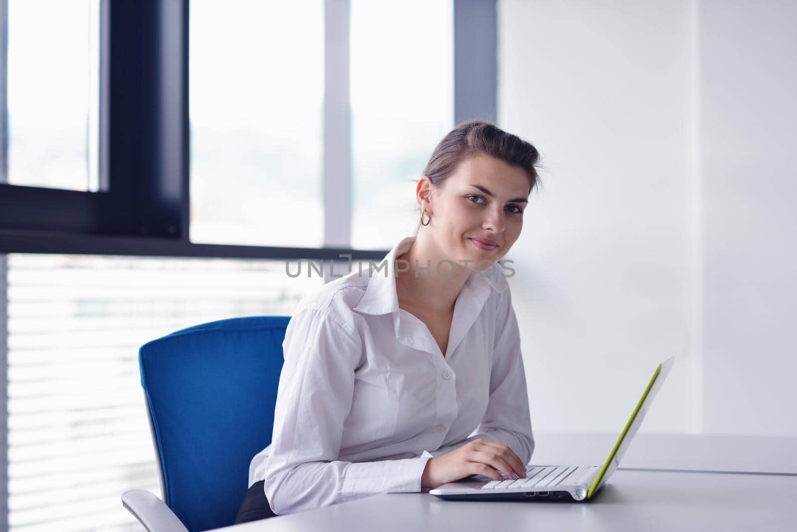 Young pretty business woman with notebook in the office by dotshock