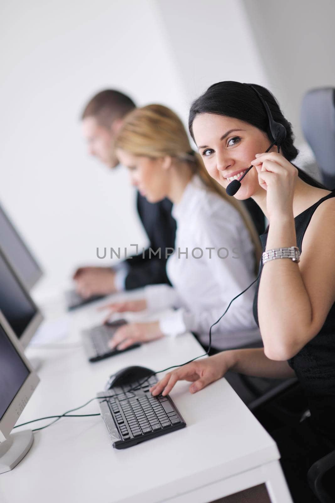 business people group working in customer and help desk office by dotshock