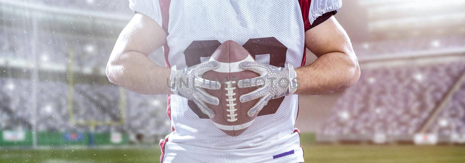 Closeup Portrait of a strong muscular American Football Player on big modern stadium field with lights and flares