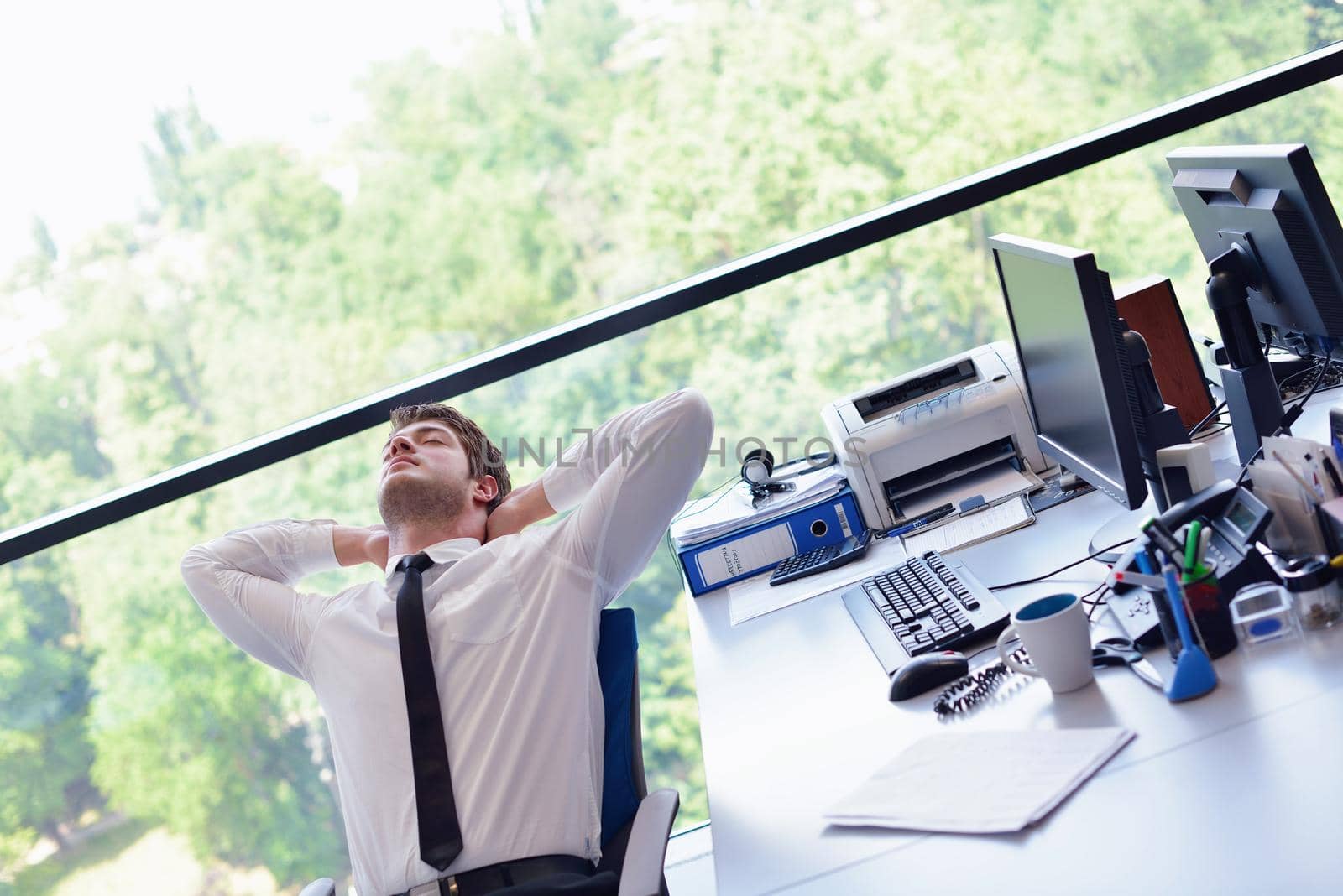 happy young business  man work in modern office on computer