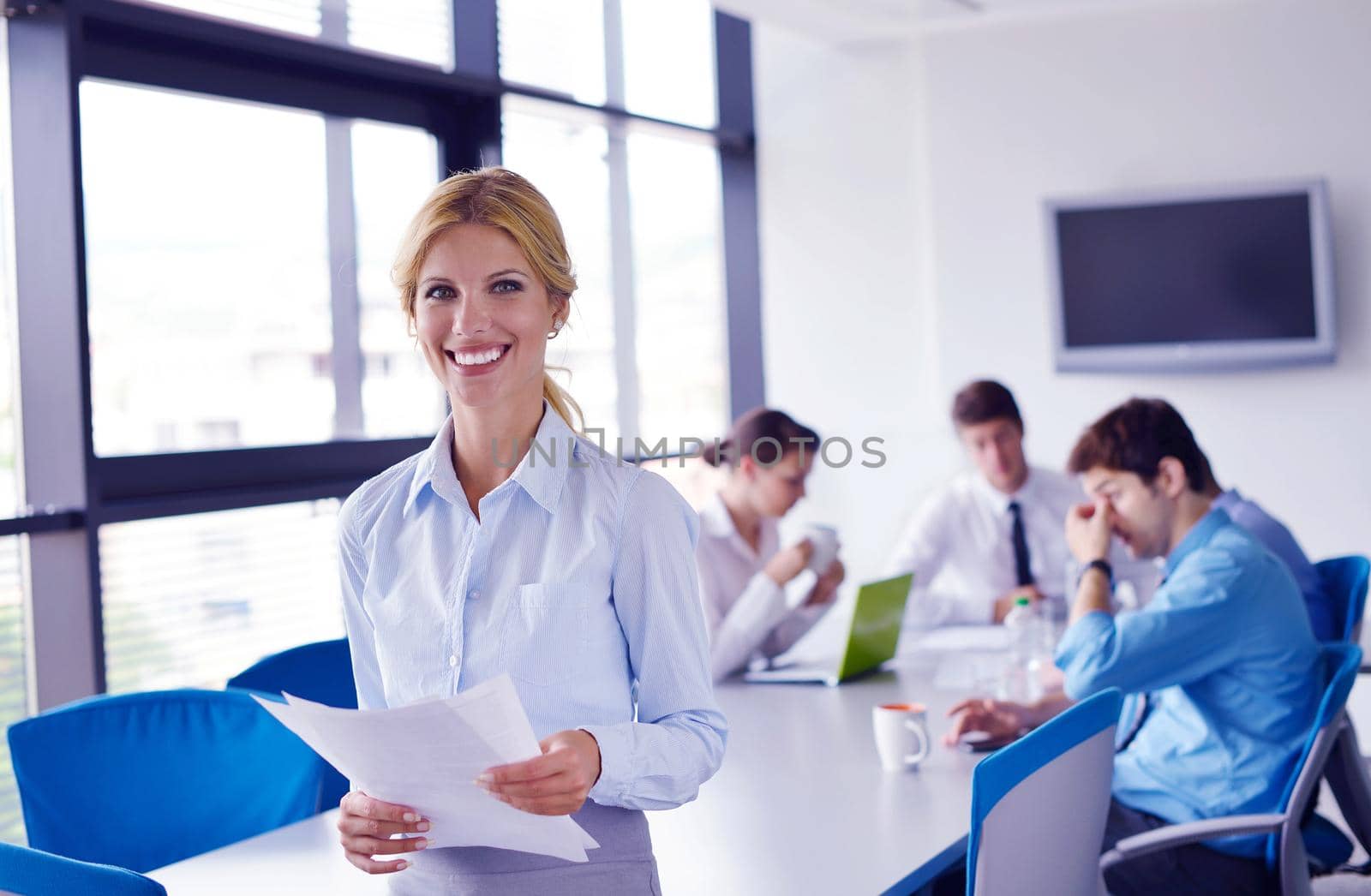 business woman  with her staff,  people group in background at modern bright office indoors