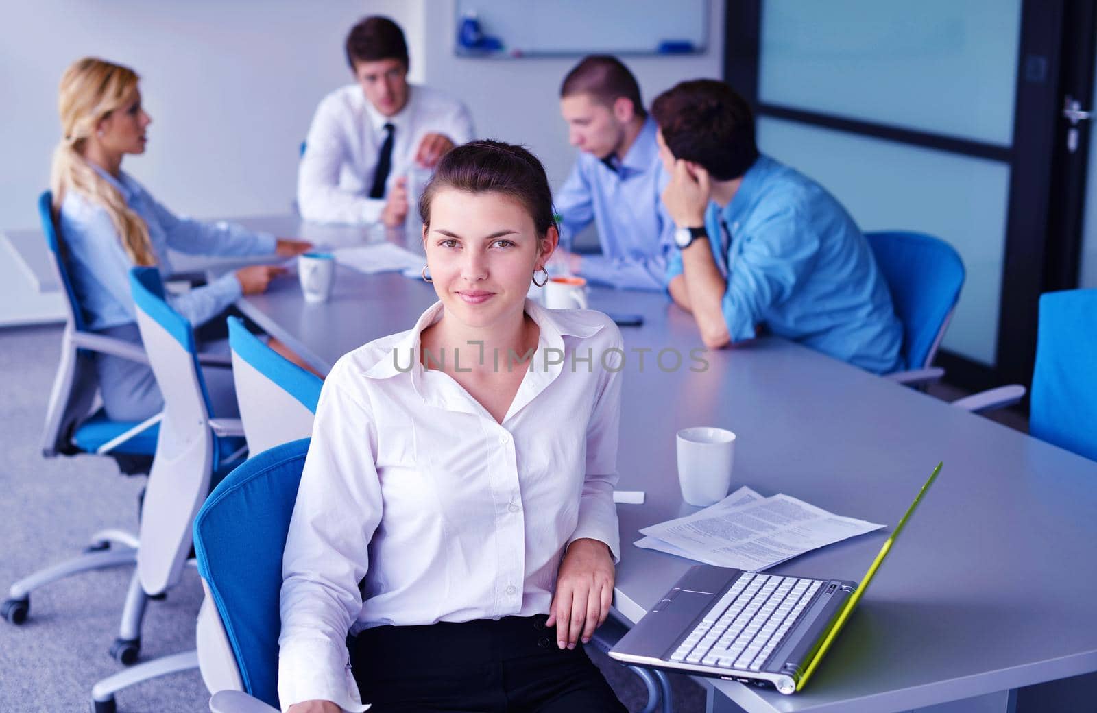 business woman  with her staff,  people group in background at modern bright office indoors