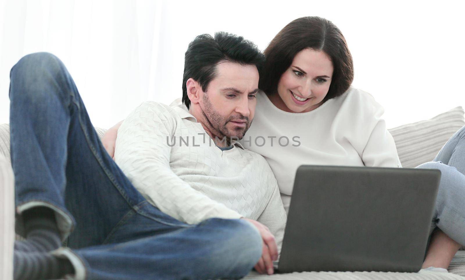 close up.young couple looking at laptop screen. by asdf
