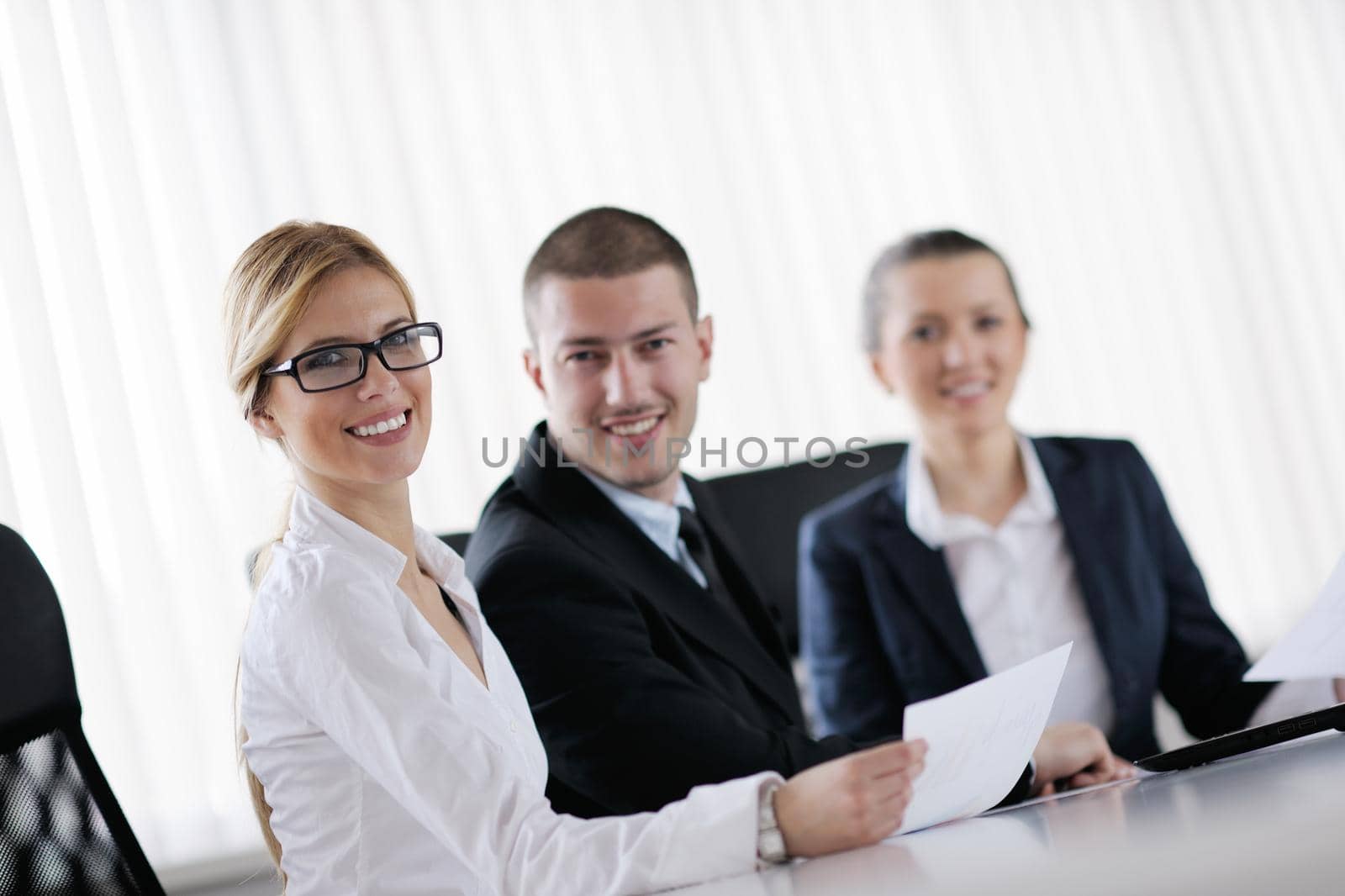 Group of happy young  business people in a meeting at office