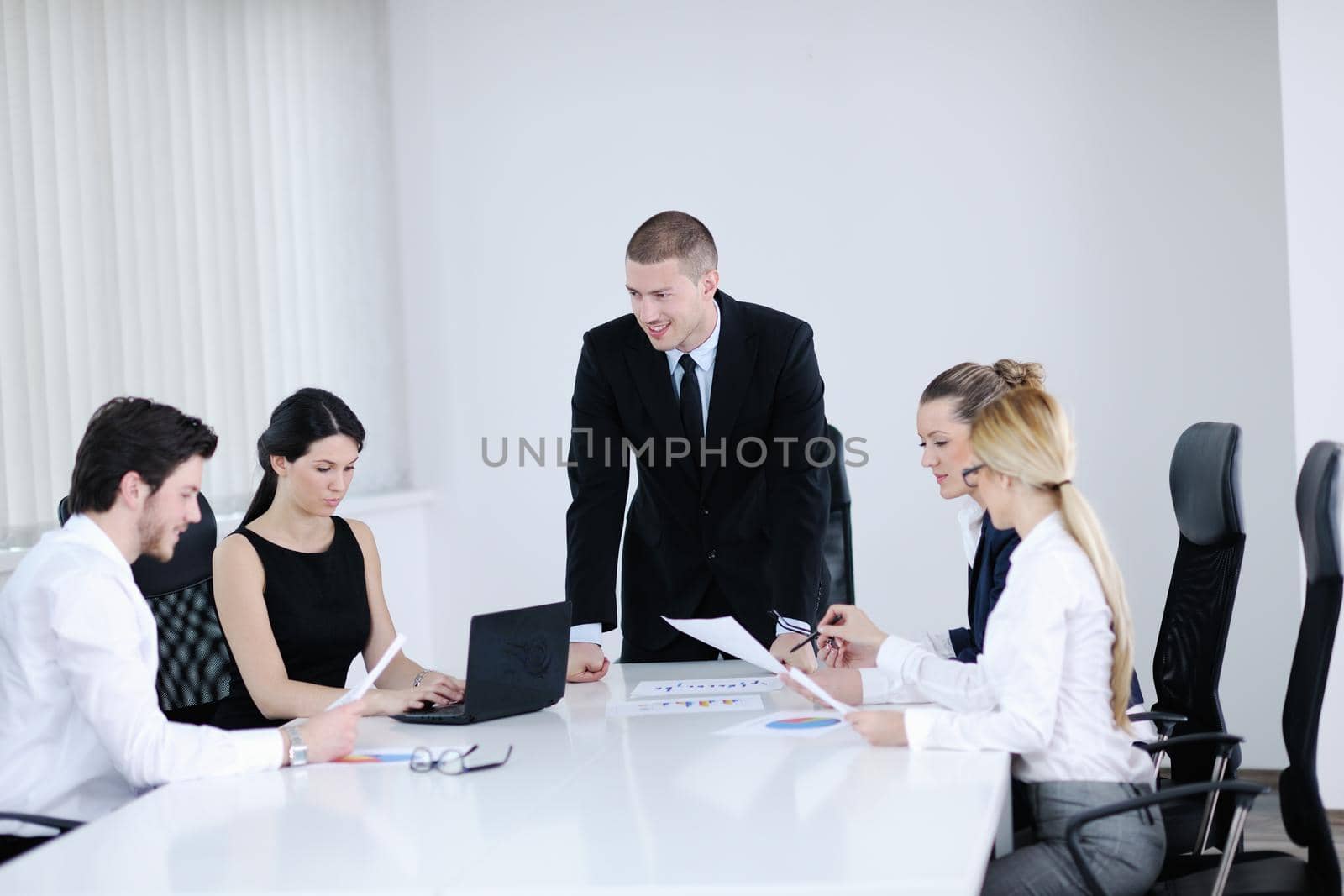 Group of happy young  business people in a meeting at office