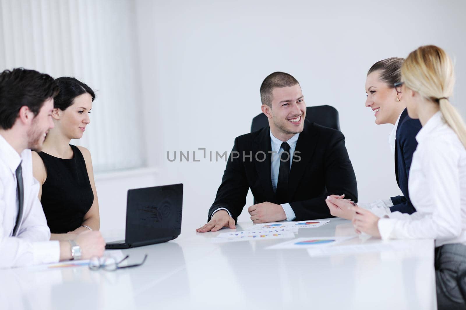 Group of happy young  business people in a meeting at office