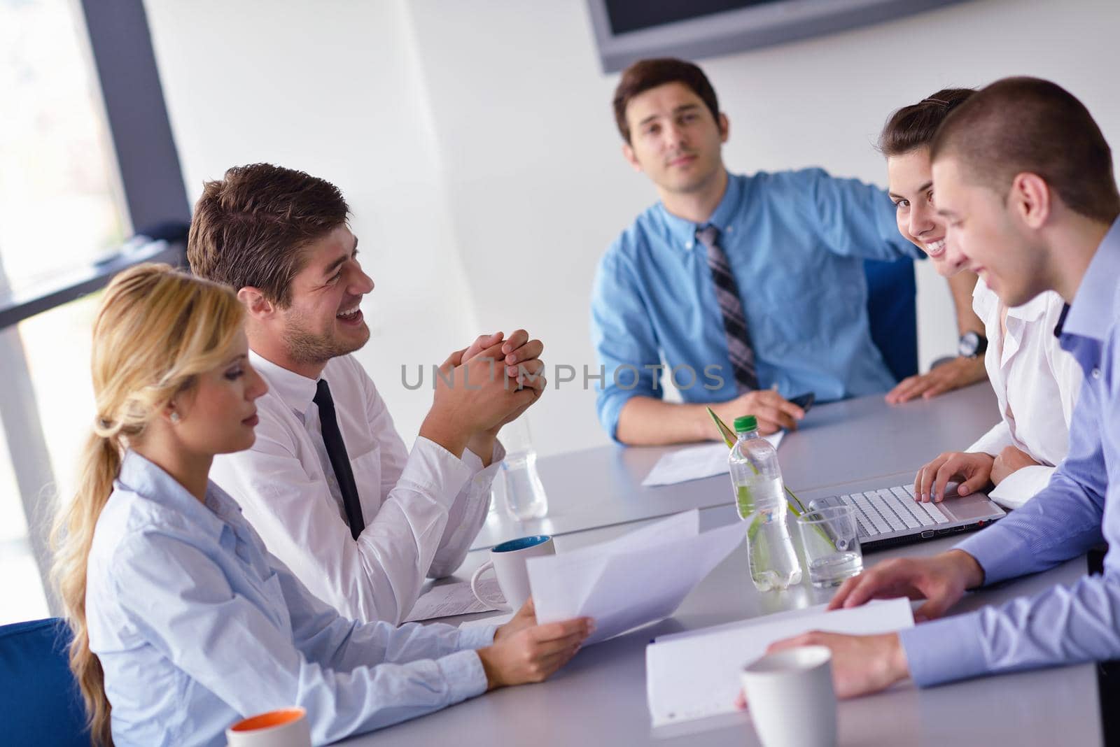 Group of happy young  business people in a meeting at office