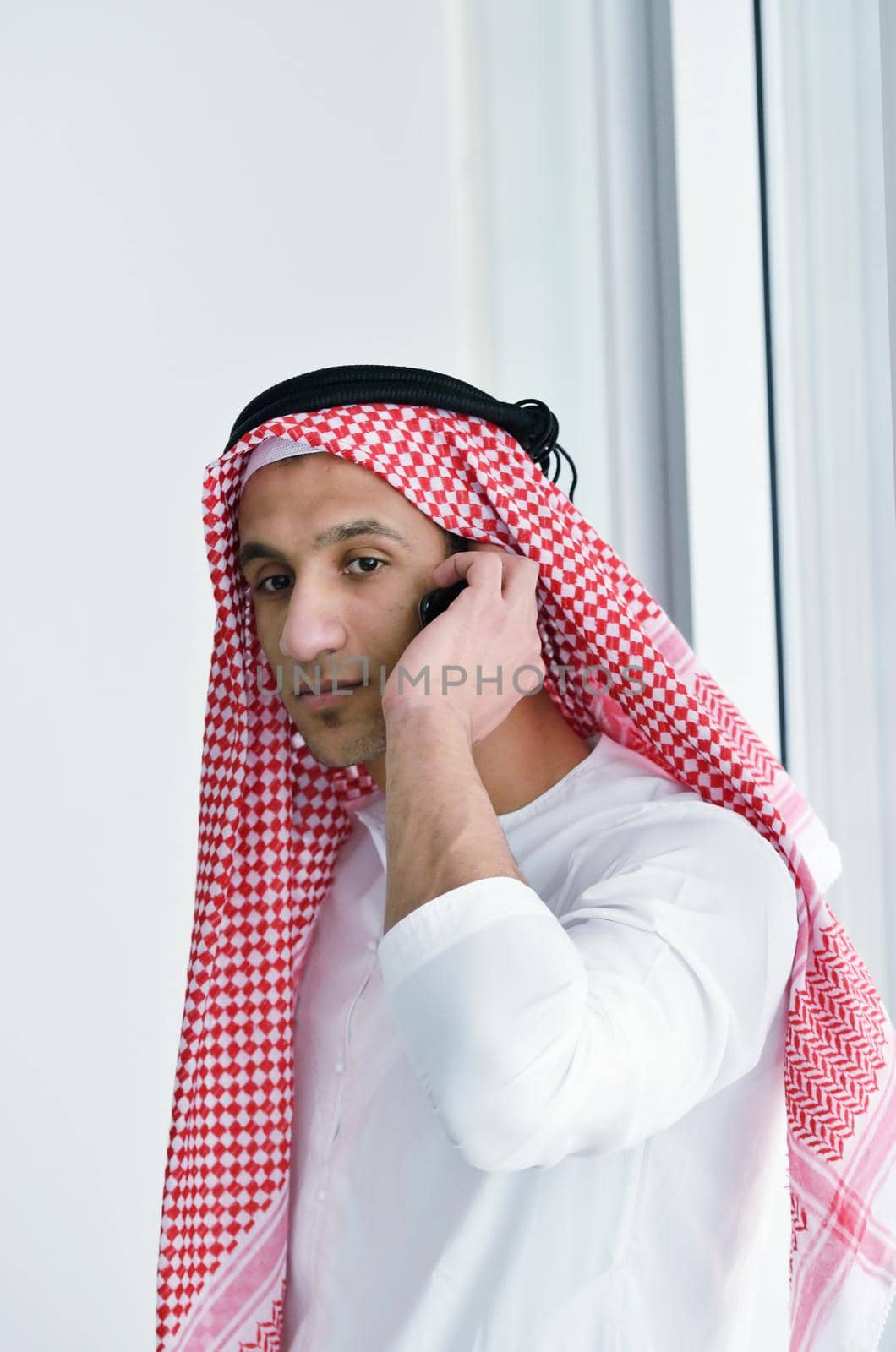 happy young arabic business man working at bright office