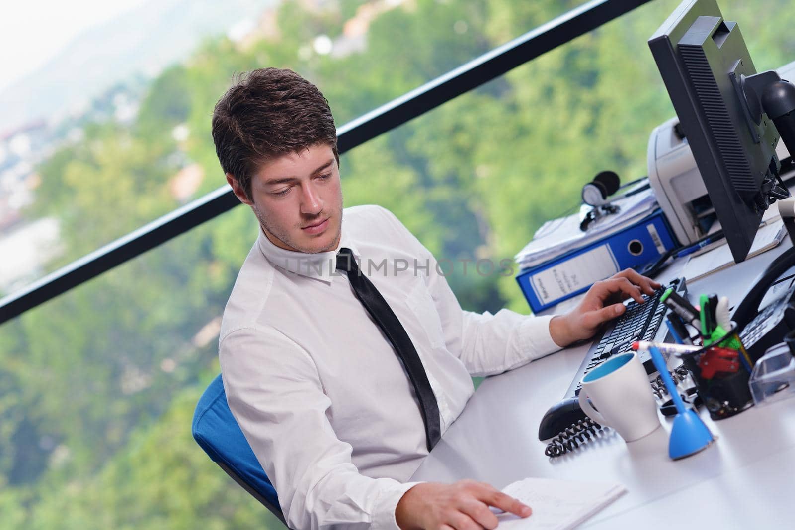 happy young business man at office by dotshock