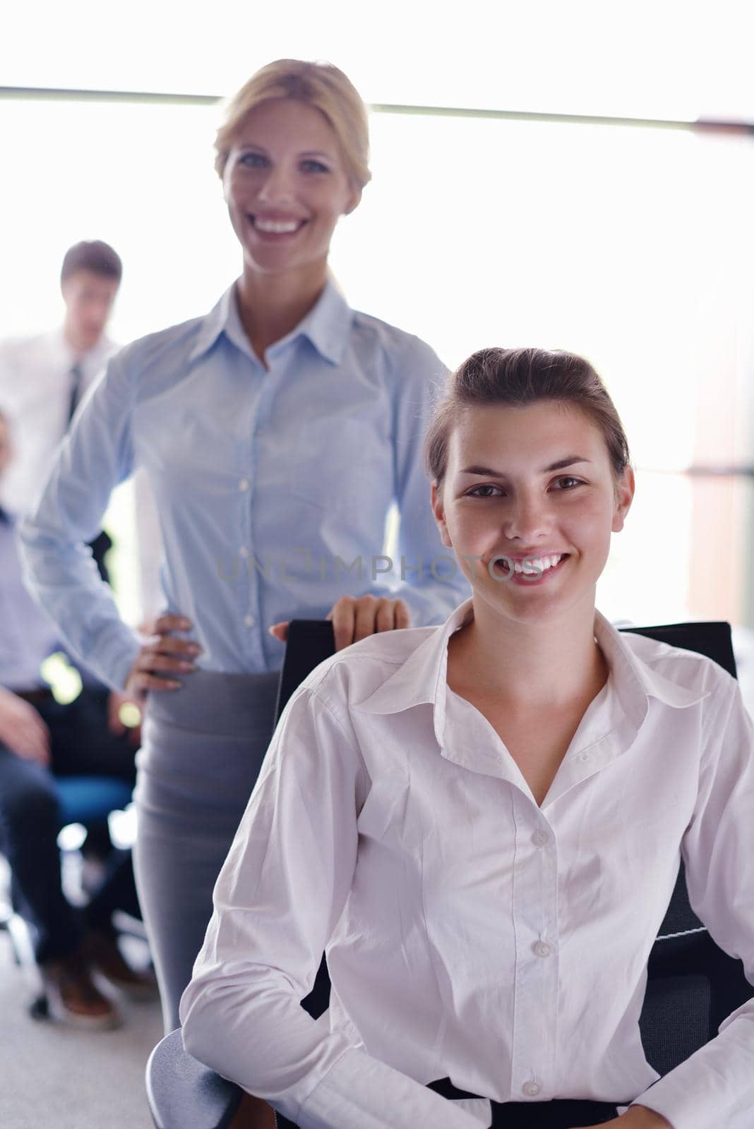 business woman  with her staff,  people group in background at modern bright office indoors