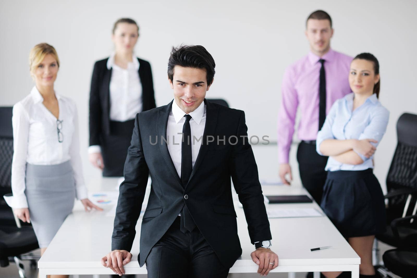 Confident young business man attending a meeting with his colleagues