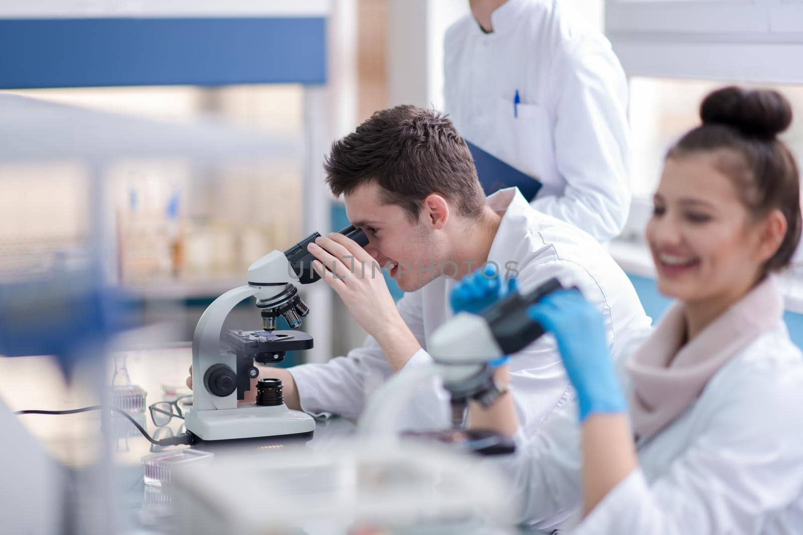 Group of young medical students doing research together in chemistry laboratory,teamwork by college student indoors