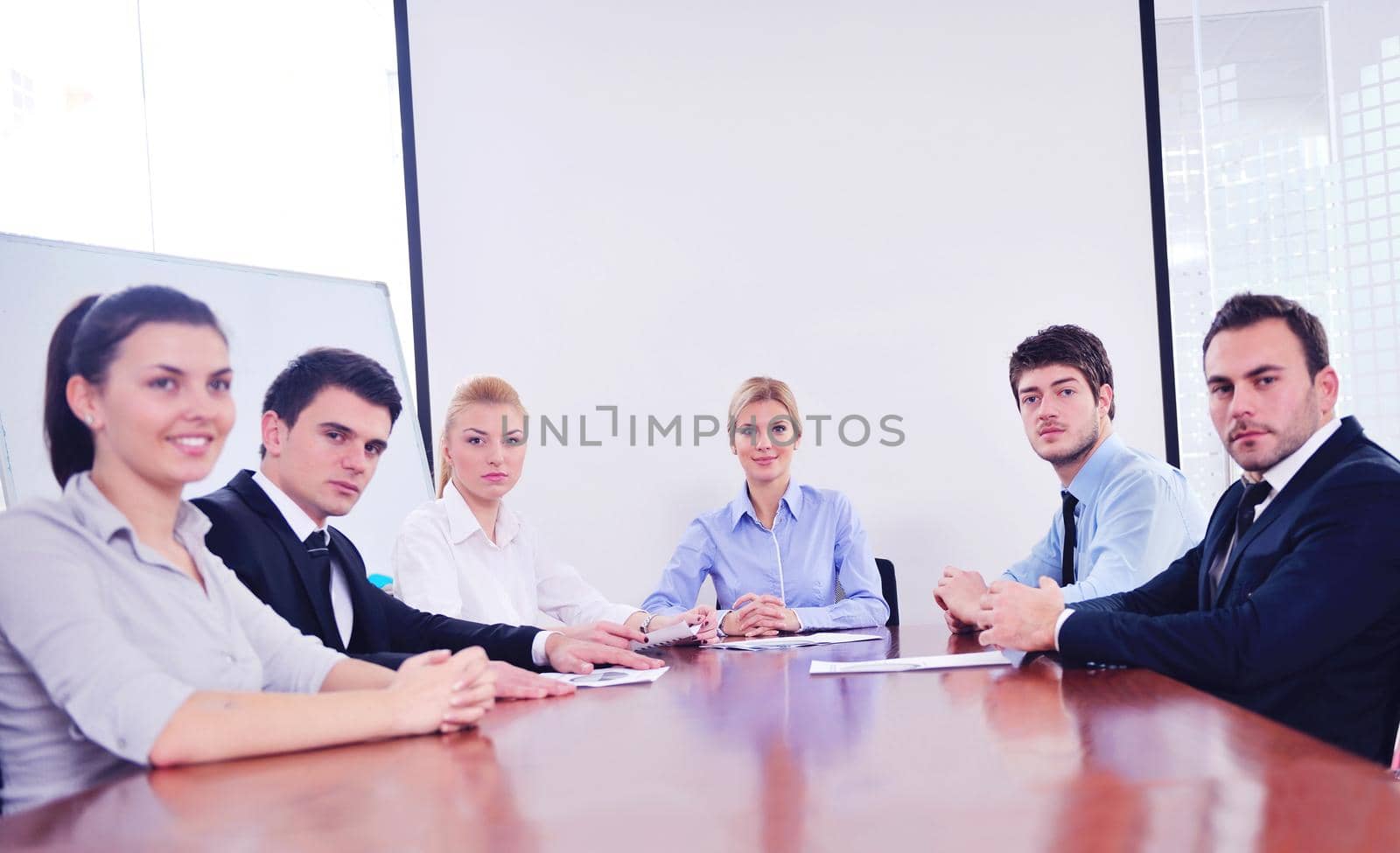 Group of happy young  business people in a meeting at office