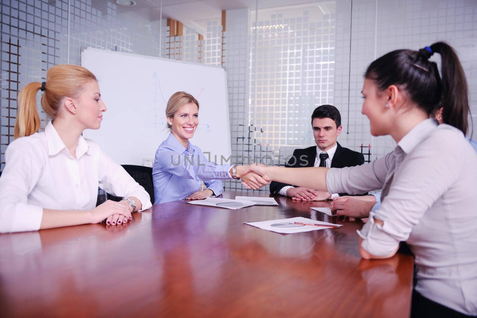 business people shaking hands make deal and sign contract in bright modern office