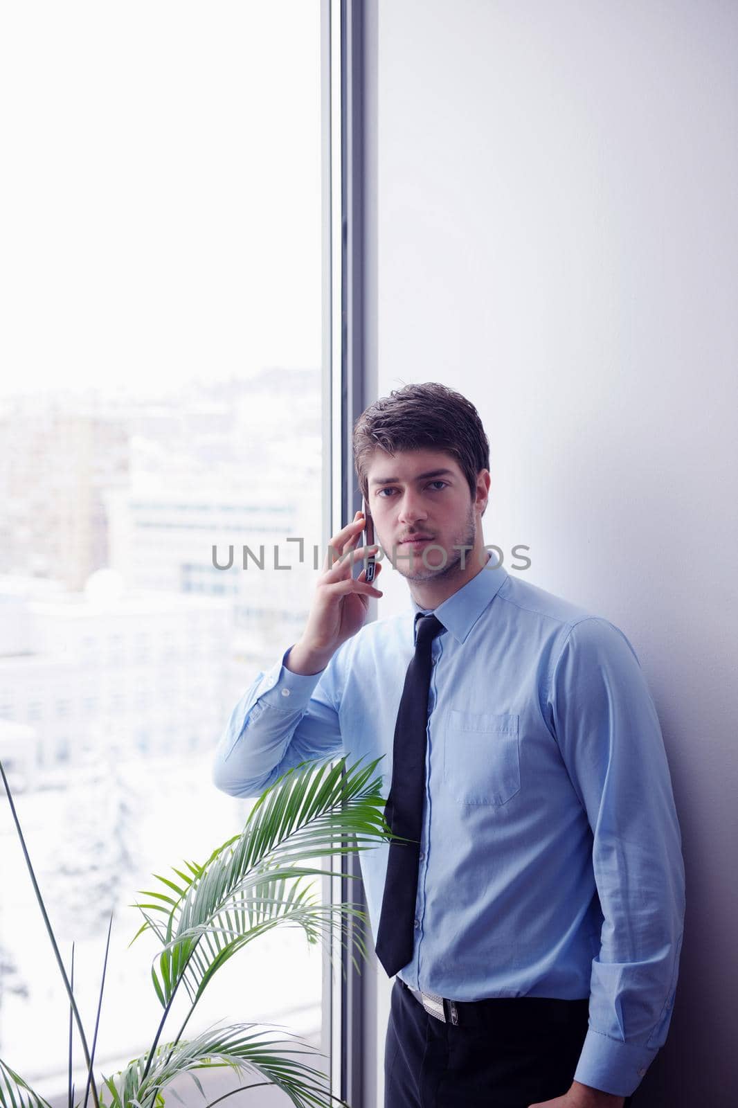 business man talking by cellphone in office