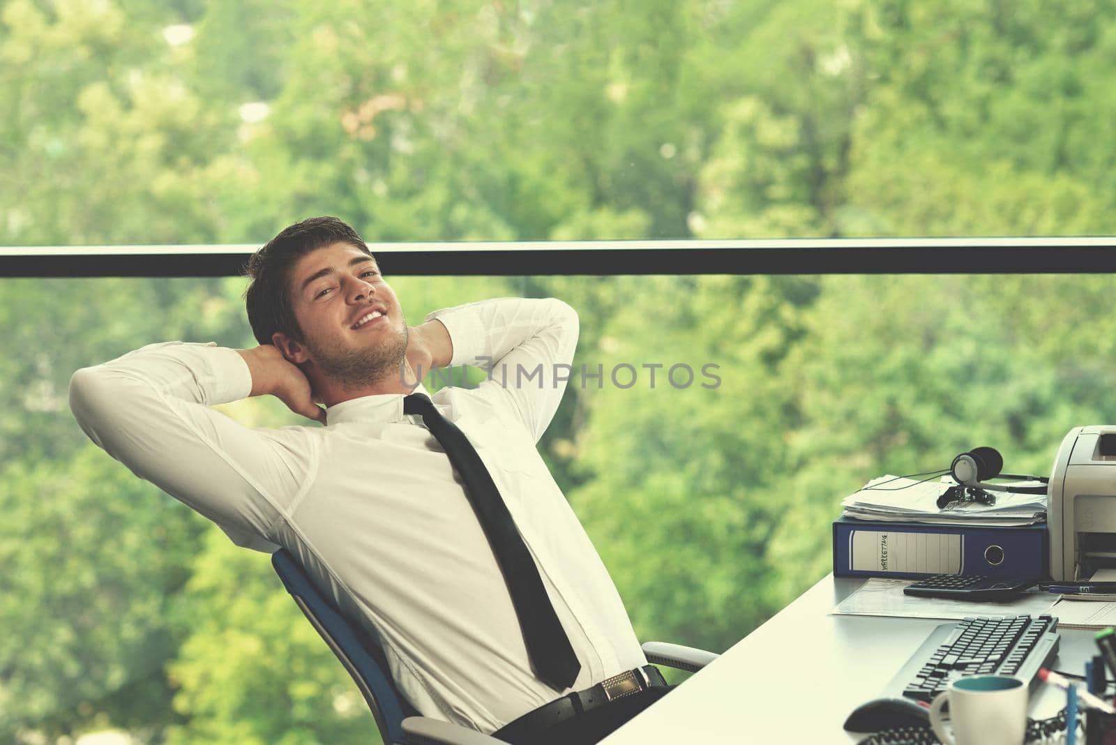 happy young business  man work in modern office on computer