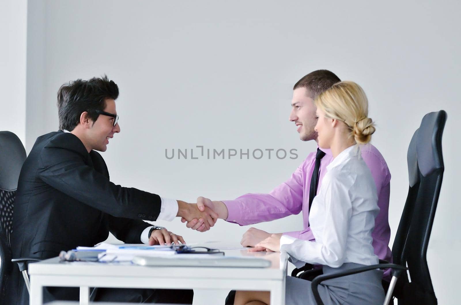 Group of young business people at meeting by dotshock