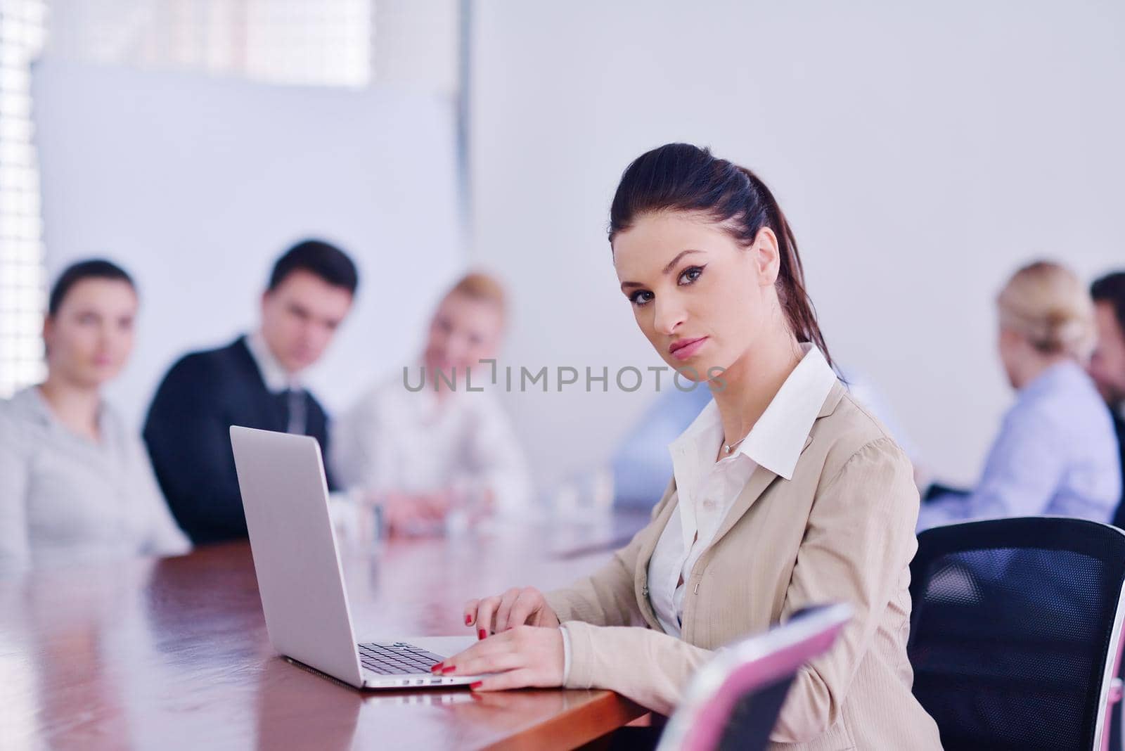 business woman  with her staff,  people group in background at modern bright office indoors