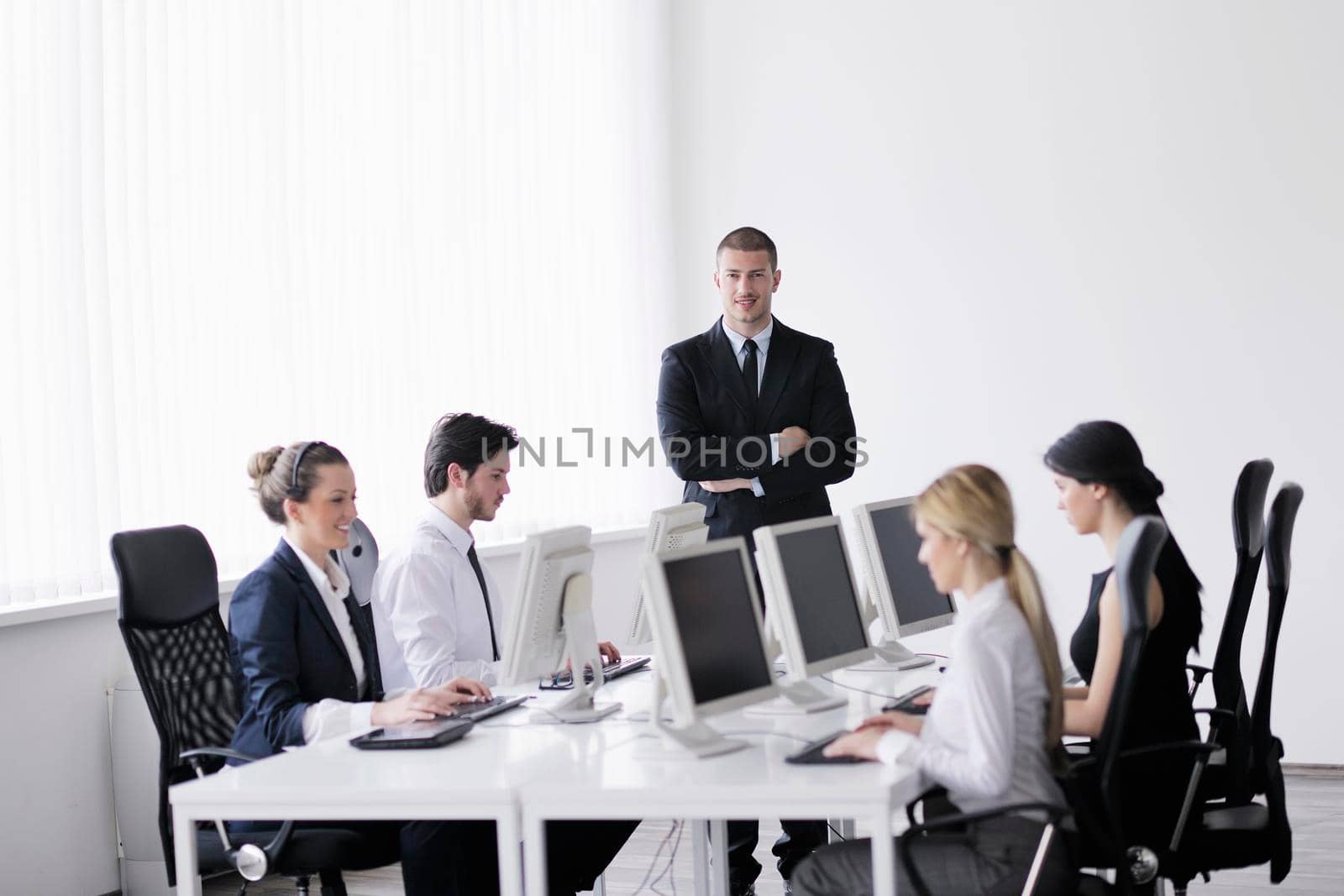 business people group with  headphones giving support in  help desk office to customers, manager giving training and education instructions