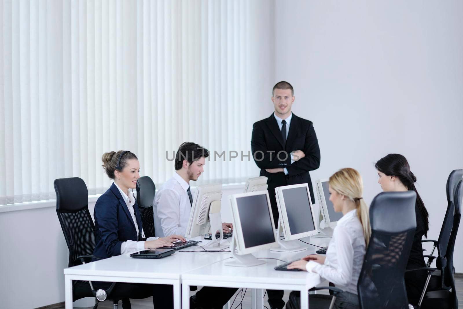 business people group working in customer and help desk office by dotshock