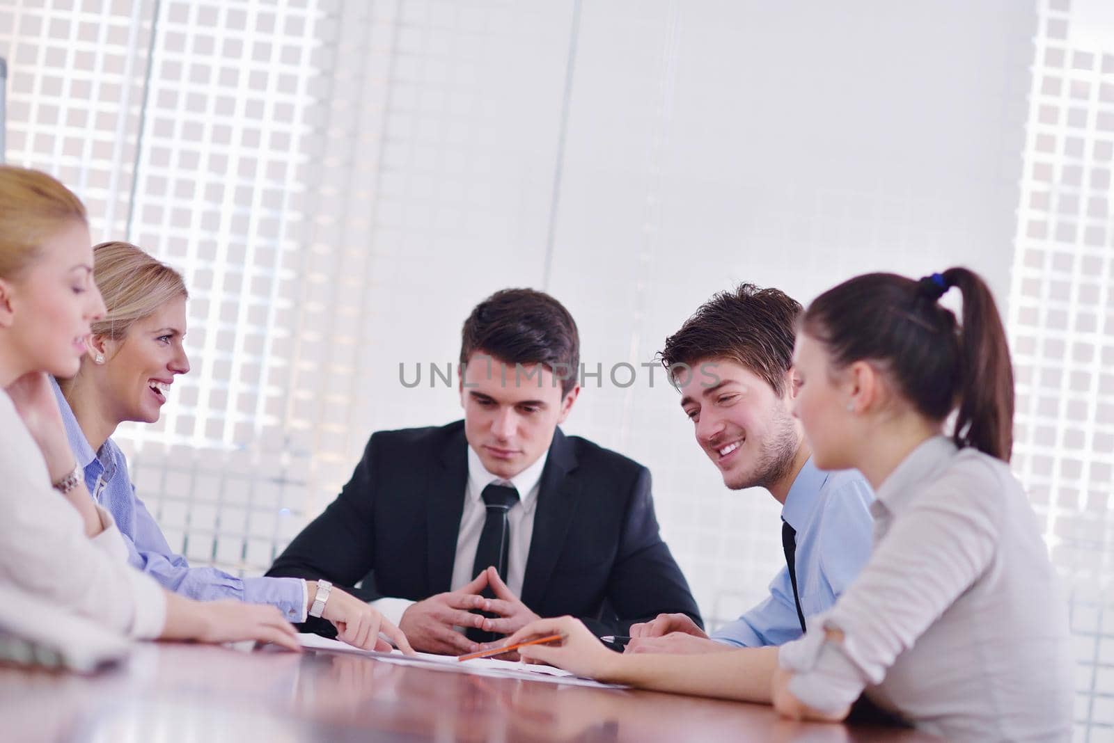 Group of happy young  business people in a meeting at office