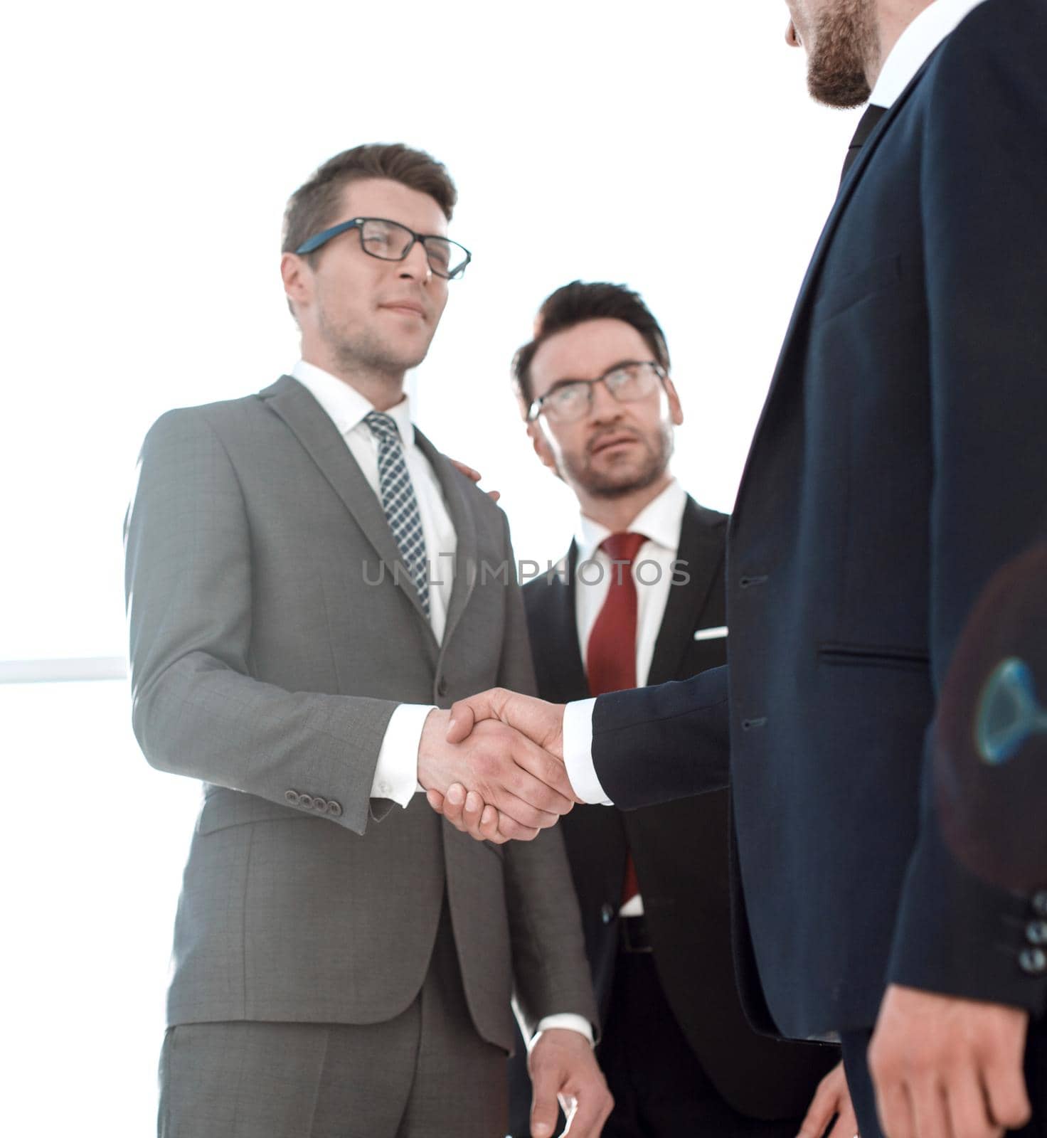 two businessmen shaking hands by asdf