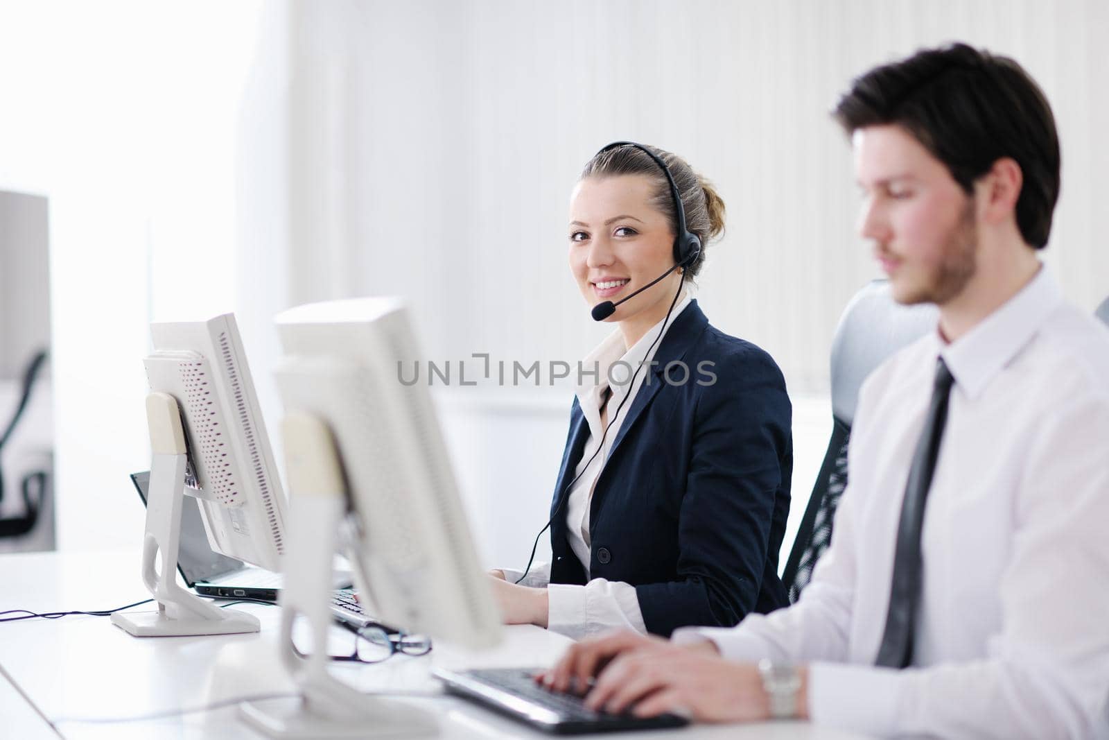 business people group with  headphones giving support in  help desk office to customers, manager giving training and education instructions