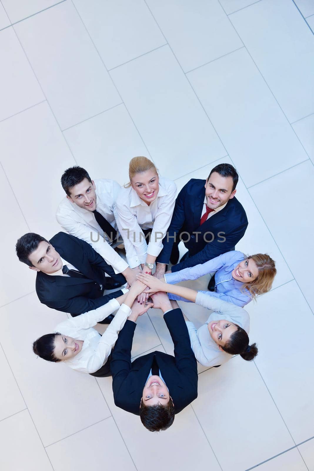 business people group joining hands and stay as team in circle  and representing concept of friendship and teamwork