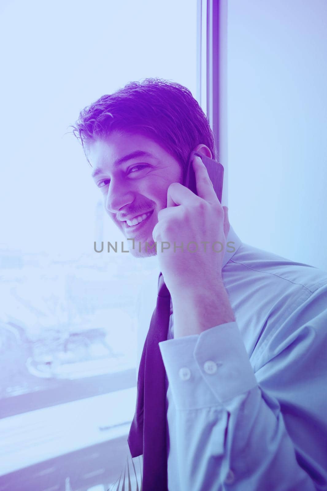 business man talking by cellphone in office