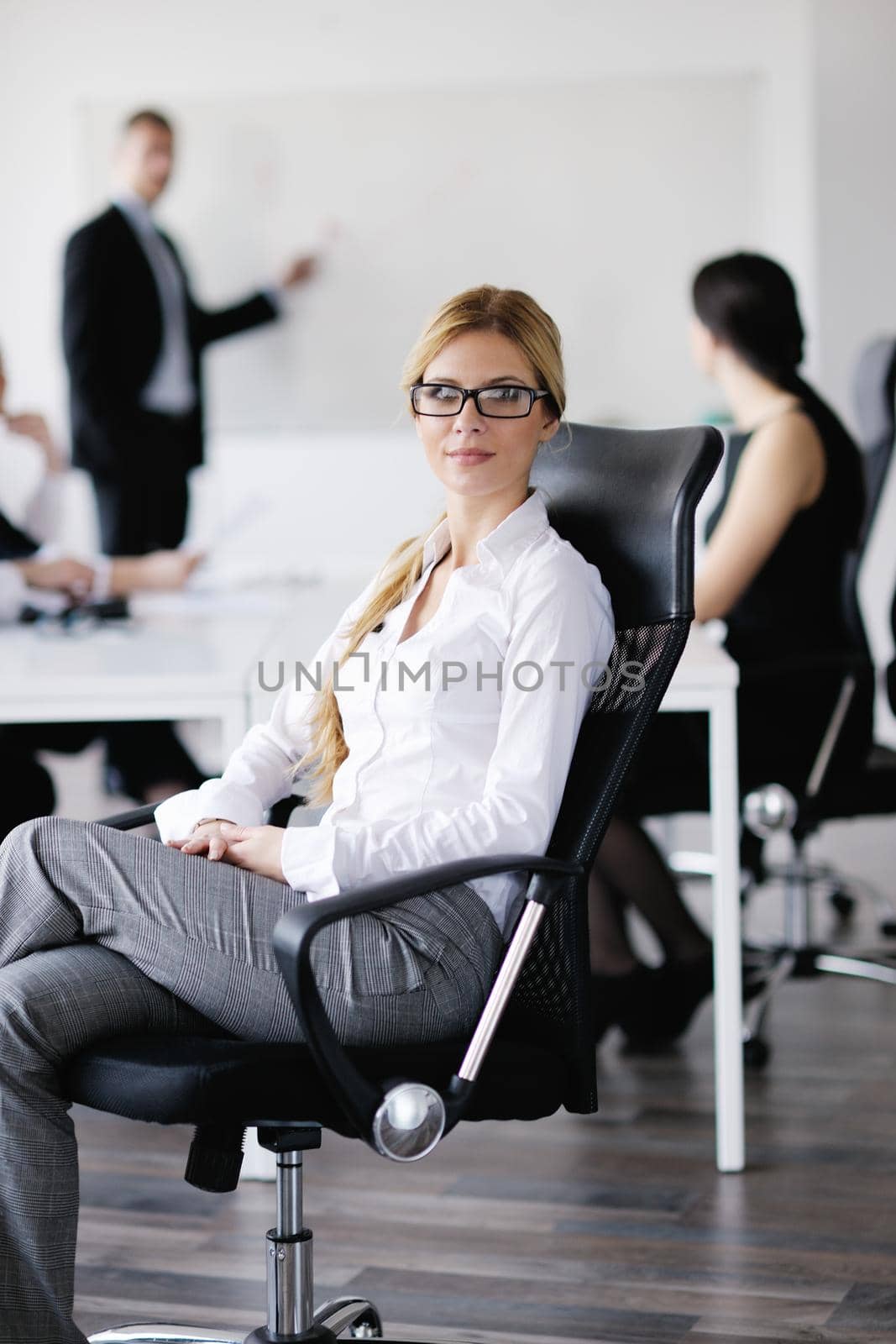 business woman with her staff in background by dotshock