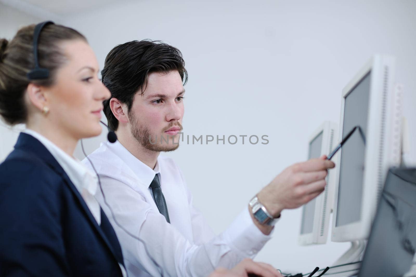 business people group with  headphones giving support in  help desk office to customers, manager giving training and education instructions