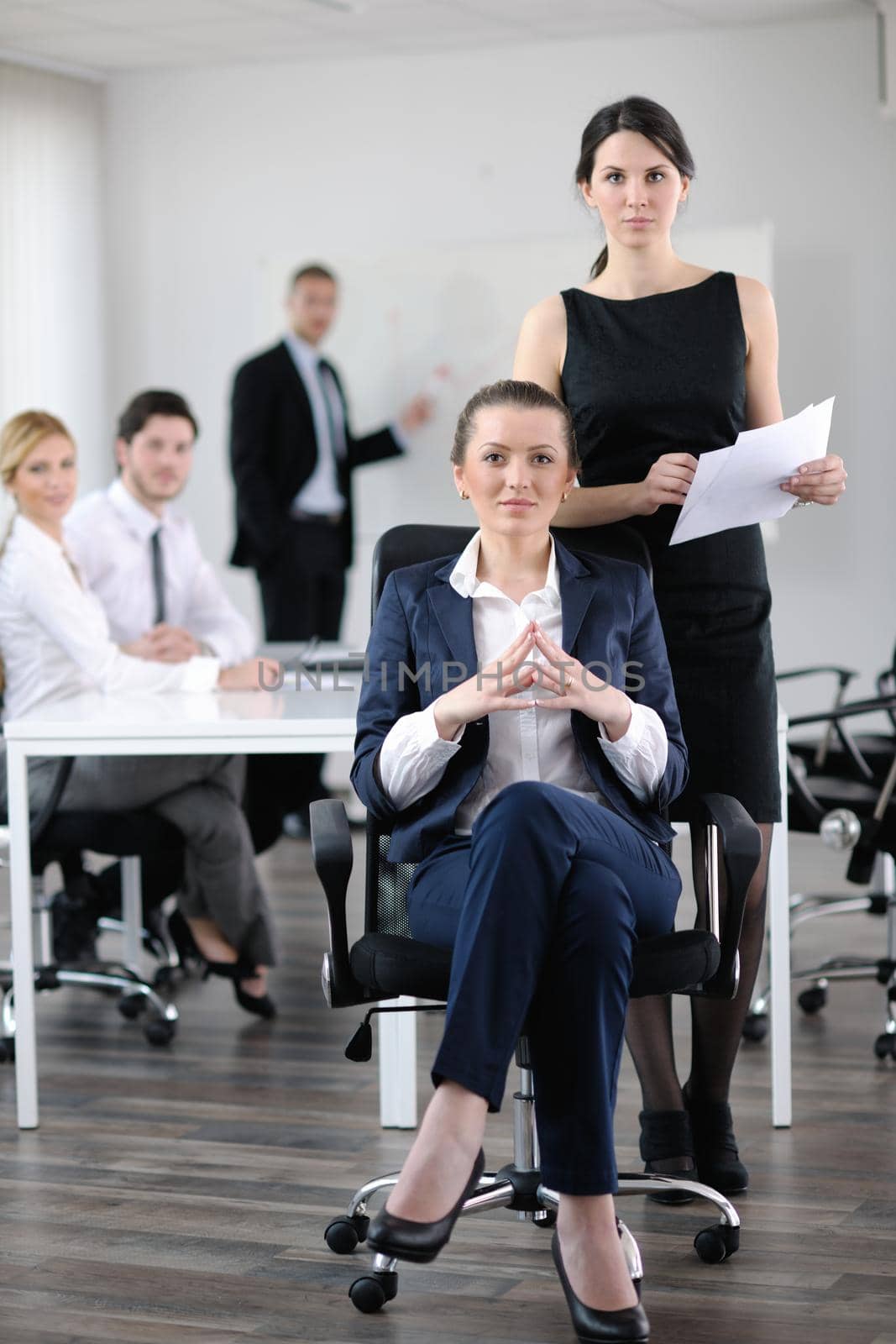 business woman  with her staff,  people group in background at modern bright office indoors