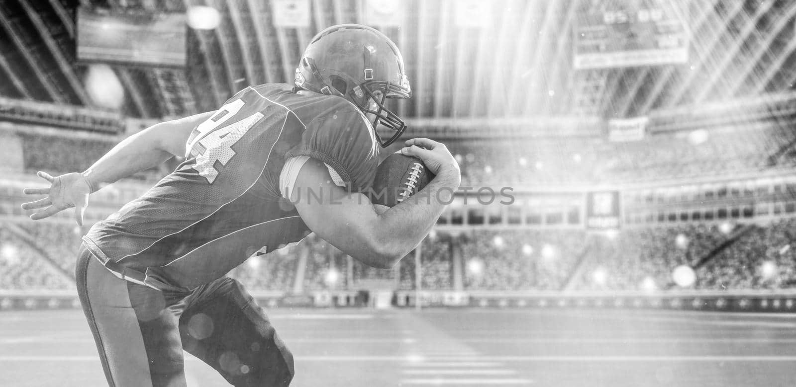 American football Player running with the ball isolated on big modern stadium field with lights and flares