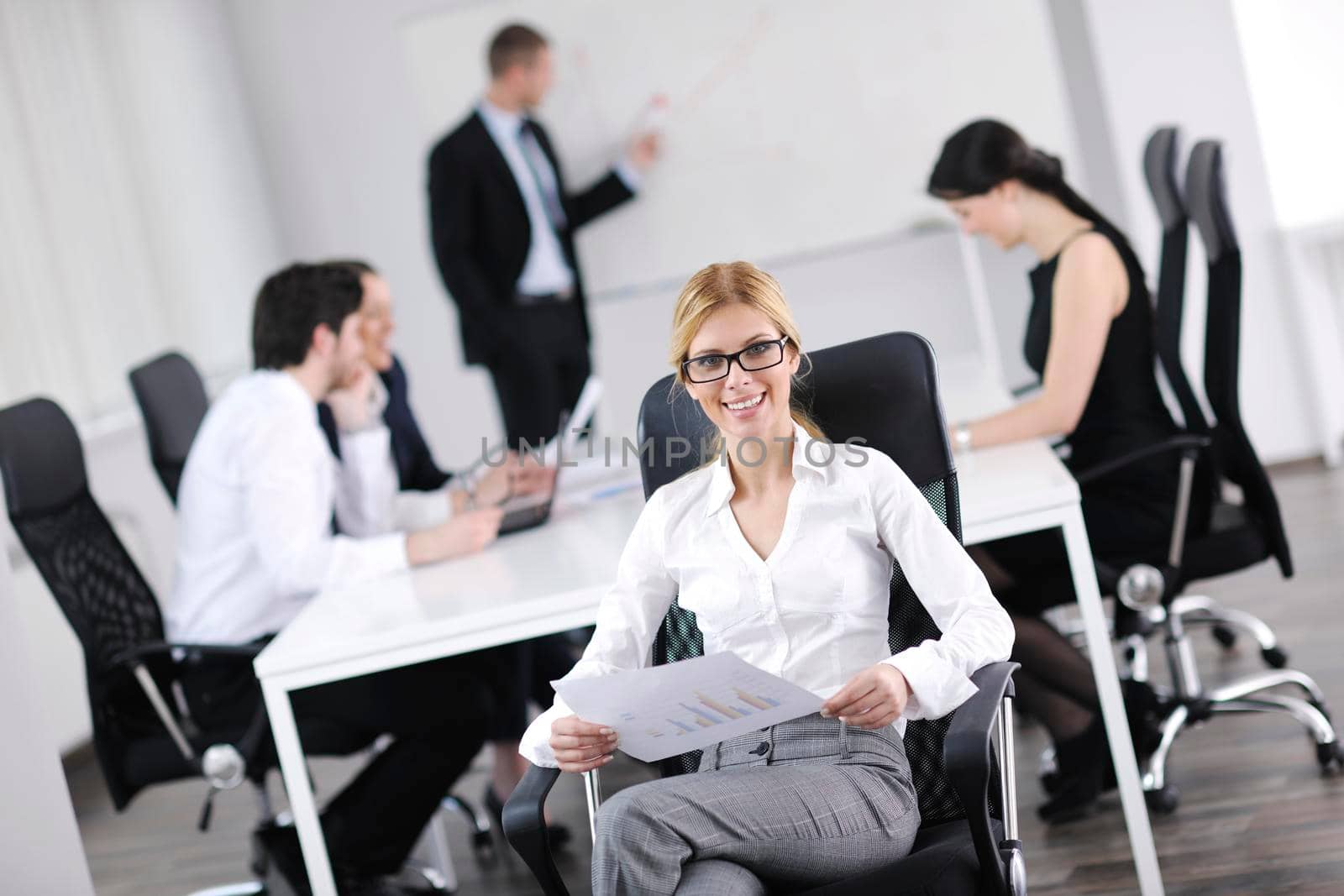 business woman  with her staff,  people group in background at modern bright office indoors