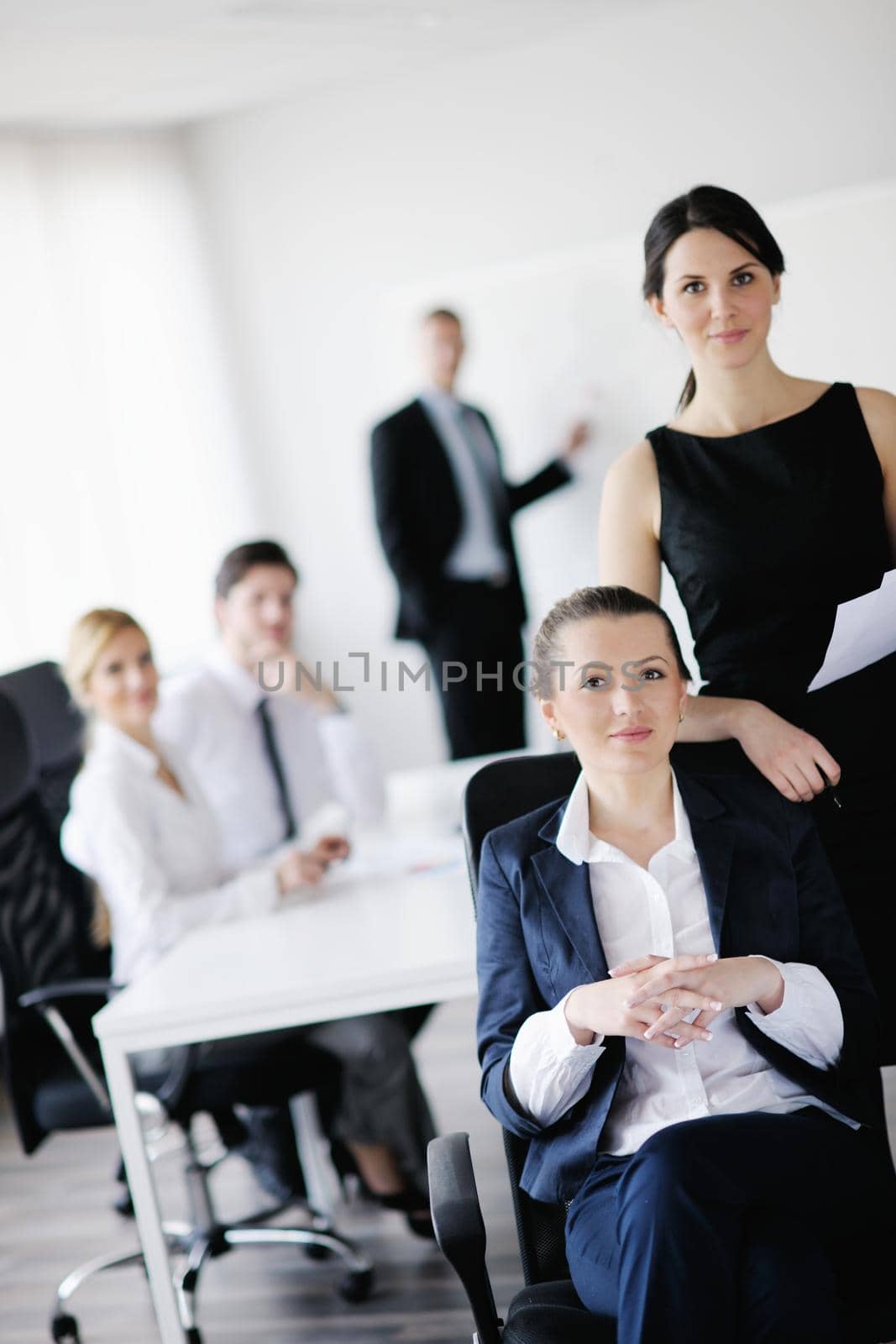 business woman  with her staff,  people group in background at modern bright office indoors