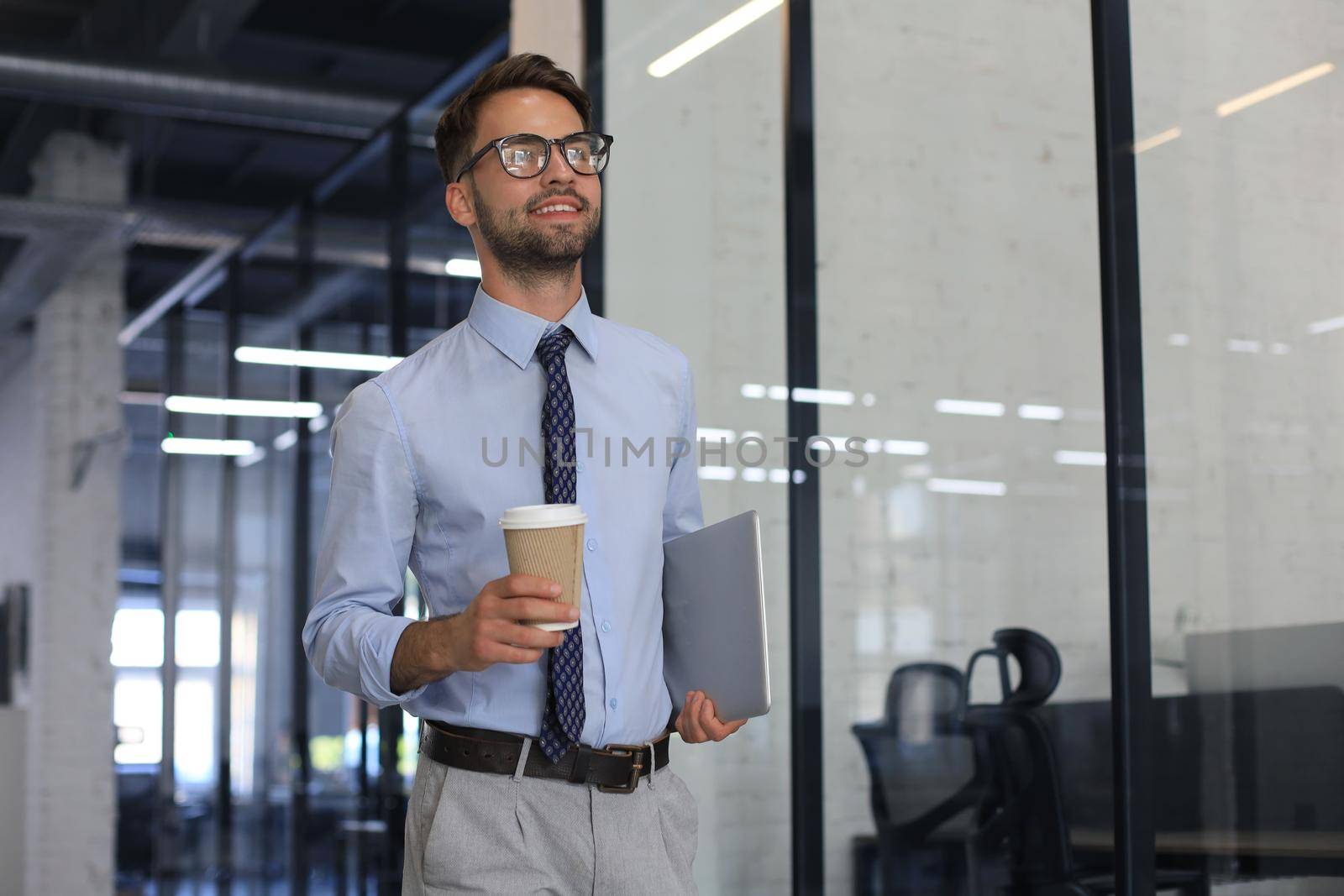 Young handsome businessman smiling in an office environment