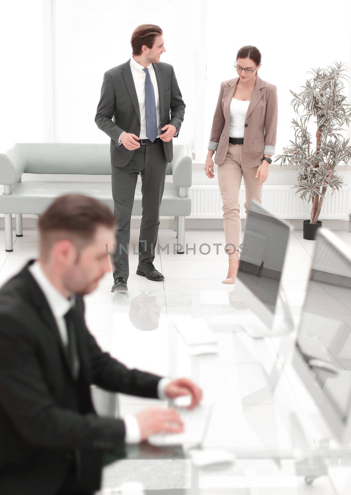 businessman uses a computer with the Bank lobby by asdf